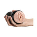 Hand holding a black cylindrical male pleasure toy with a realistic textured vaginal opening in vanilla color.
