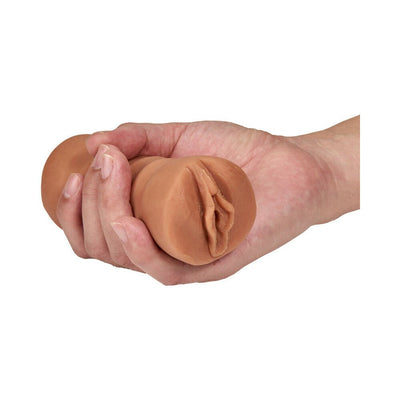 Hand holding a mocha tan M For Men Sofia soft textured vagina stroker sleeve.
