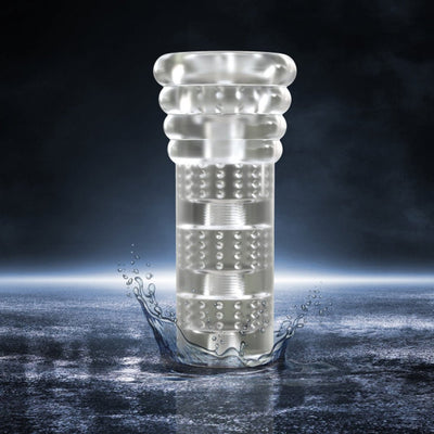 Clear textured M For Men Soft And Wet All Nighter stroker with ribbed design standing in water splash on dark background.