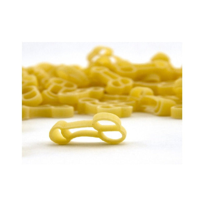 Close-up of uncooked novelty pasta shaped for adult-themed party dishes on a white background.