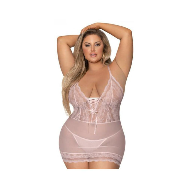 Plus size model wearing blush pink lace-up chemise with matching mesh G-string and delicate lace trim hem