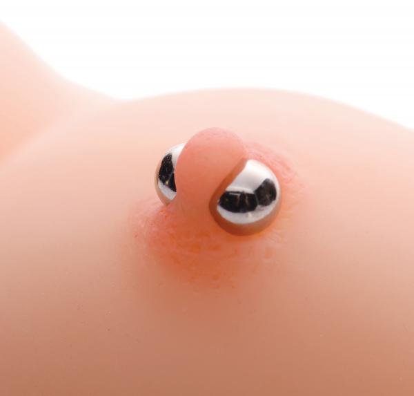 Close-up of two silver magnetic orbs clamped on skin, demonstrating intense pressure and secure hold.