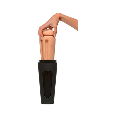 Hand holding a removable flesh-toned sleeve from a black cylindrical male masturbator device.