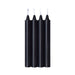 Four black sensual warm drip candles with white wicks, standing upright on a white background.