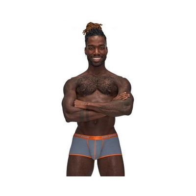 Male model wearing Casanova Uplift Mini Shorts in black and blue with orange trim, standing with arms crossed and smiling.