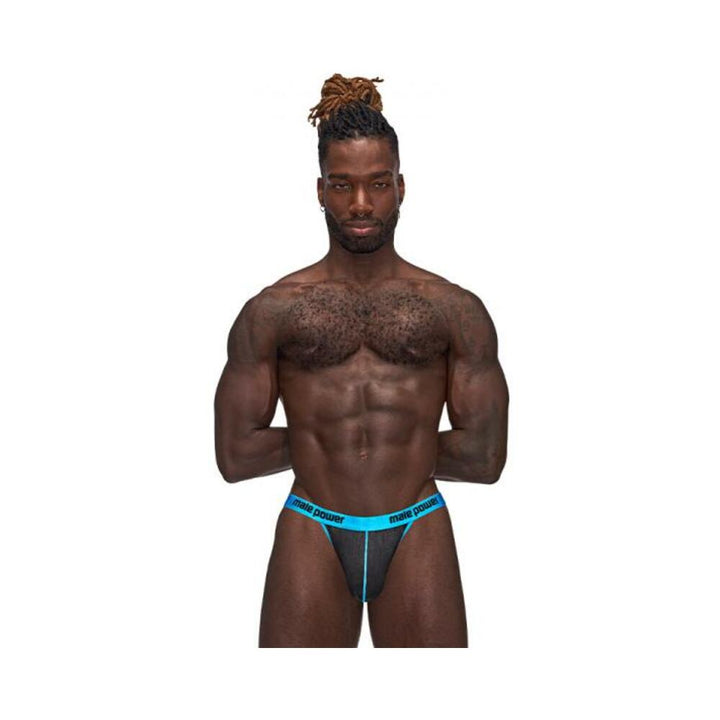 Muscular man wearing Male Power Casanova Uplift Thong in black with bright blue waistband and trim, standing against white background.