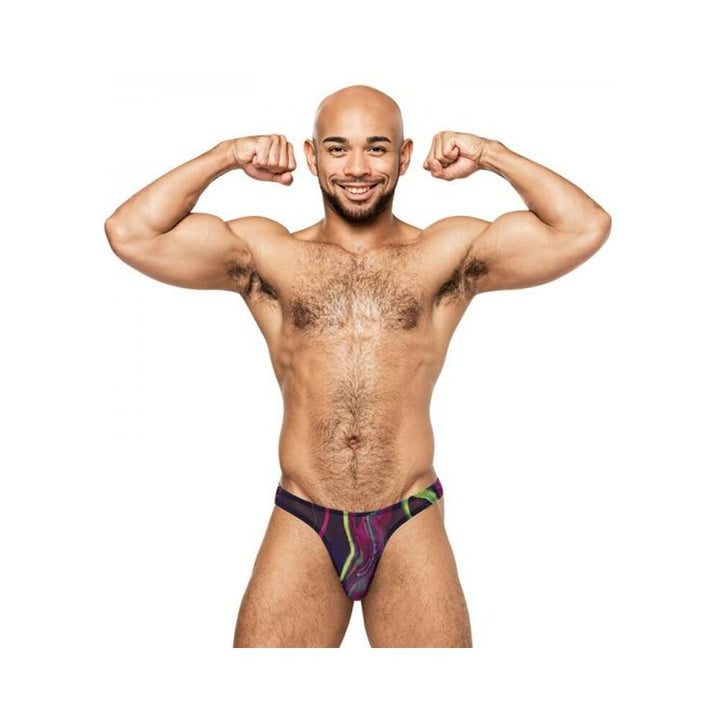 Smiling muscular man flexing arms wearing colorful Galactic Bong thong with cosmic print on white background