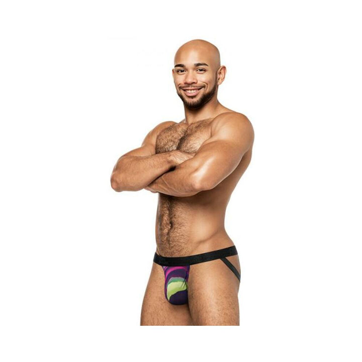 Smiling muscular man wearing Male Power Galactic Strappy Ring Jock with vibrant cosmic print and black elastic straps.