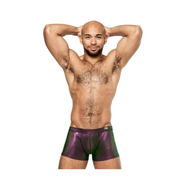 Man wearing Male Power Hocus Pocus Uplift Mini Shorts in shimmering purple with green tones, posing with hands behind head.