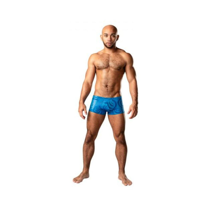 Male model wearing sky blue Kaleidickscope mini shorts with iridescent swirl pattern on white background.