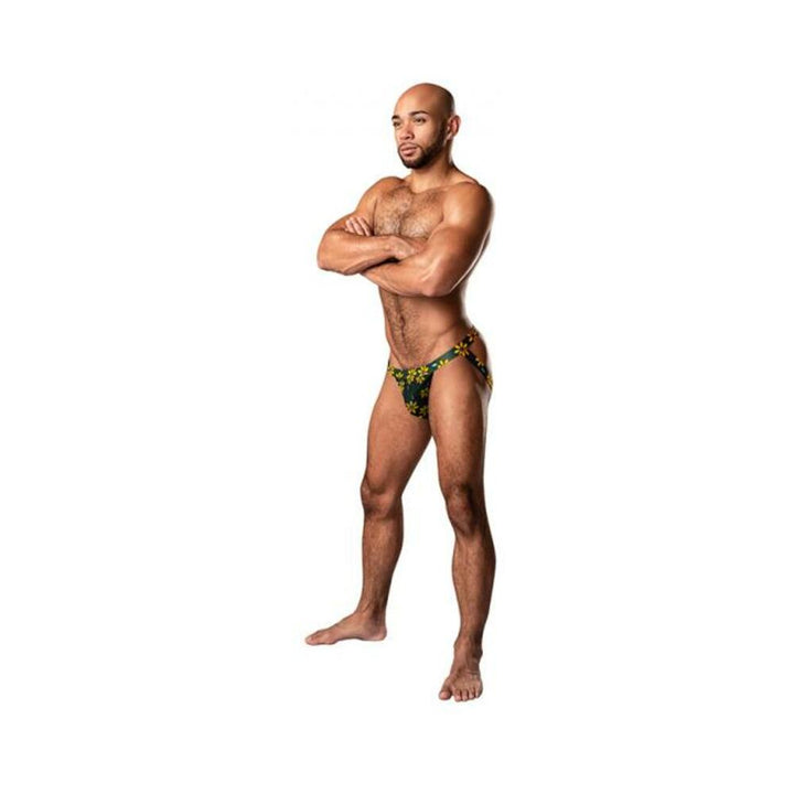 Male model wearing Male Power Petal Power jockstrap with yellow daisy print and coordinating waistband and leg bands.