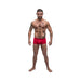 Athletic man wearing red Male Power Pure Comfort Modal Wonder Shorts standing against white background.