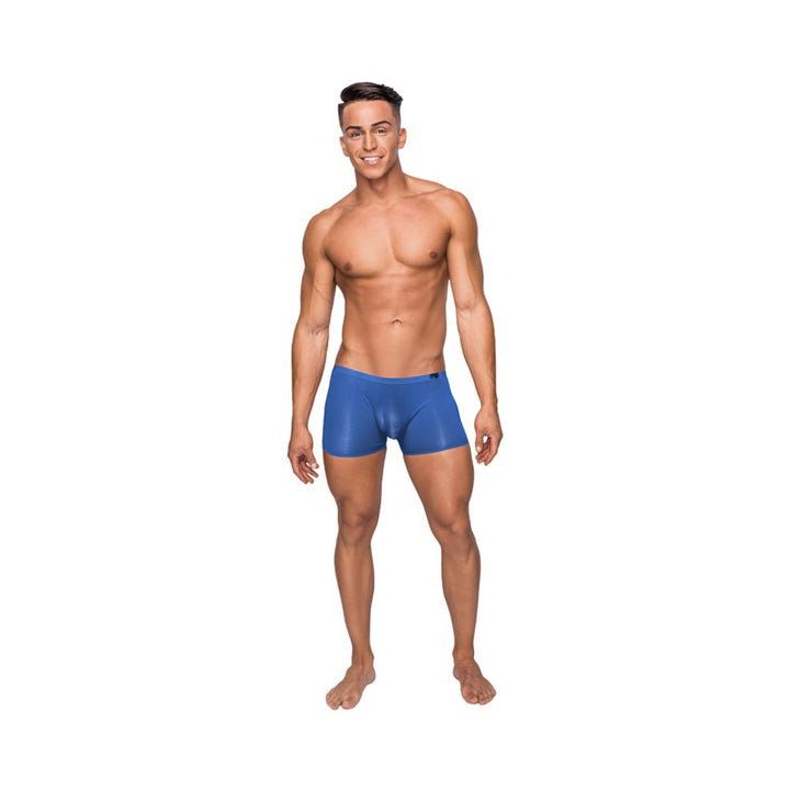 Male model wearing royal blue seamless sleek shorts with sheer pouch, standing barefoot on white background.