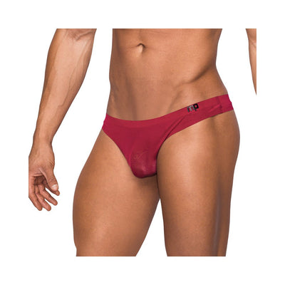 Male model wearing seamless sleek wine-colored thong with sheer pouch and low-rise waistband.