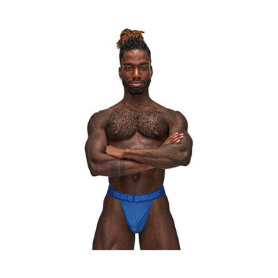 Muscular man wearing blue Male Power Sexagon Micro V Thong with branded waistband and hexagon print fabric.