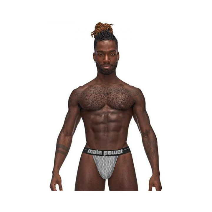 Muscular male model wearing Male Power Sexagon Micro V Thong with hexagon print and branded waistband on white background.