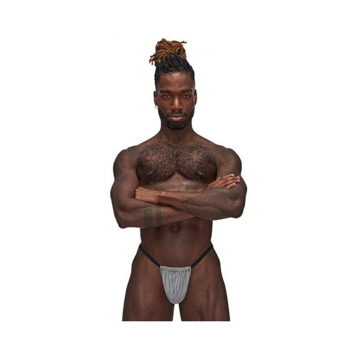 Male model wearing Male Power Sexagon Posing Strap with hexagon-print front pouch and black elastic waistband against white background.