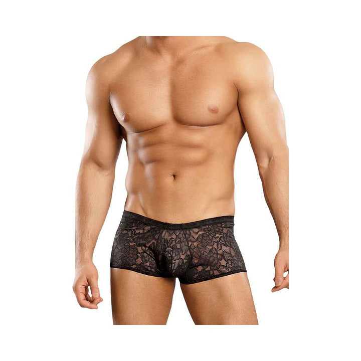 Male torso wearing black stretch lace mini shorts with floral pattern on a white background.