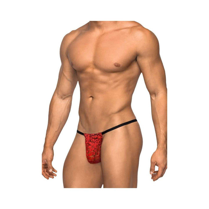 Male model wearing a red stretch lace posing strap with black waistband, showcasing a floral design and minimal coverage.