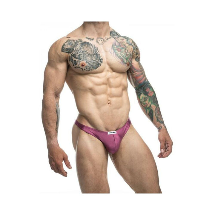 Muscular male model wearing Malebasics Justin + Simon Classic Tanga in wine color, showcasing fit and design.