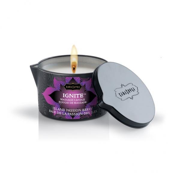 Kama Sutra Ignite massage candle in black tin with purple label, lit with matching black lid beside it.