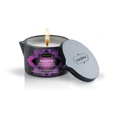 Kama Sutra Ignite massage candle in black tin with purple label, lit with matching black lid beside it.