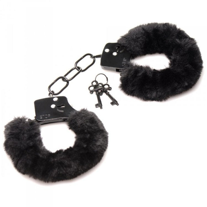 Black furry handcuffs with soft faux fur lining and two metal keys on a white background.