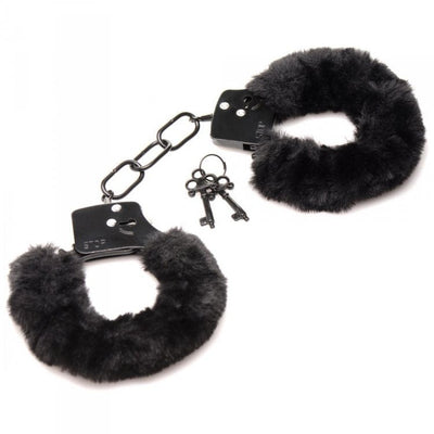 Black furry handcuffs with soft faux fur lining and two metal keys on a white background.