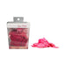 Melting rose petals in a sheer pink bag inside clear packaging with loose pink petals beside it on white background.