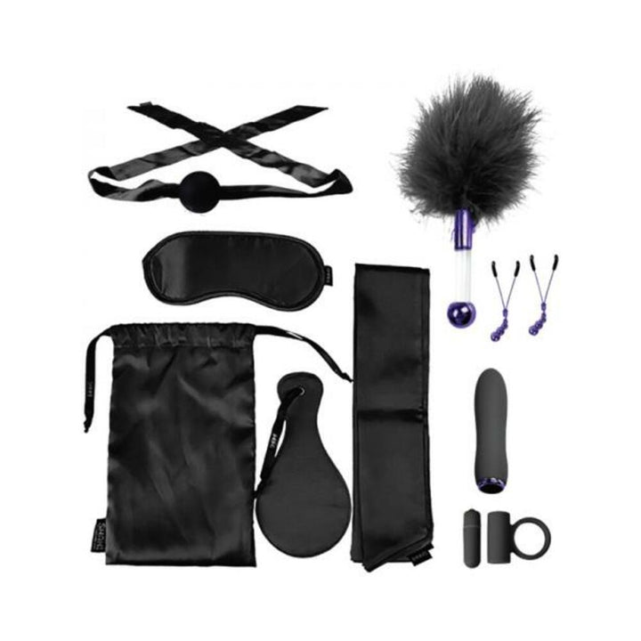 Merci The Vip Room BDSM set in black with satin blindfold, ball gag, feather tickler, nipple clamps, vibrator, c-ring, paddle, straps, and storage bag.