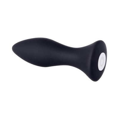 Compact black silicone butt plug with tapered tip and white power button on base, designed for comfortable, rechargeable use.
