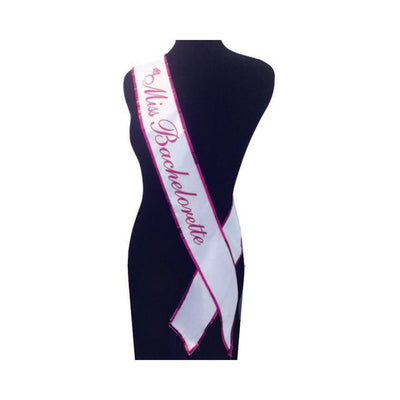 White Miss Bachelorette sash with red sequined trim displayed on a black mannequin torso.