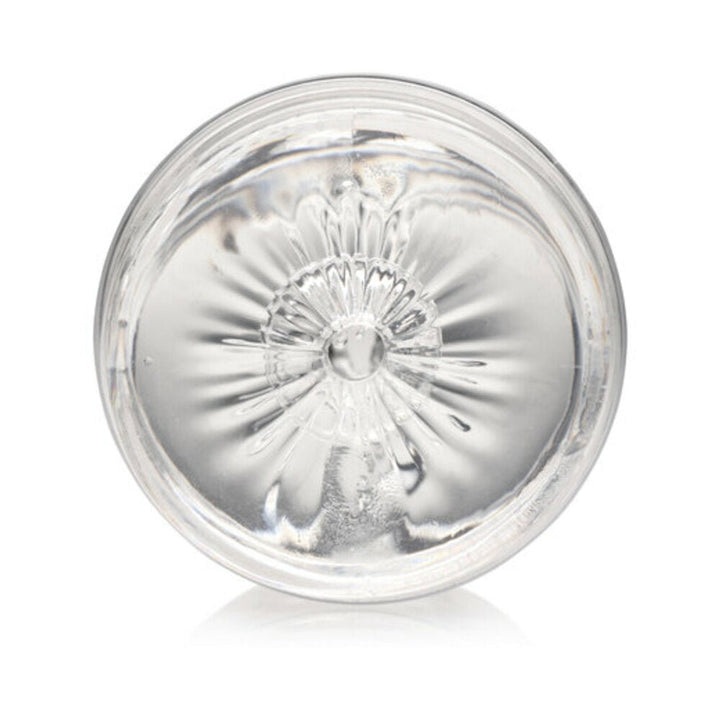 Clear round mini masturbator showing textured interior tunnel for enhanced stimulation.