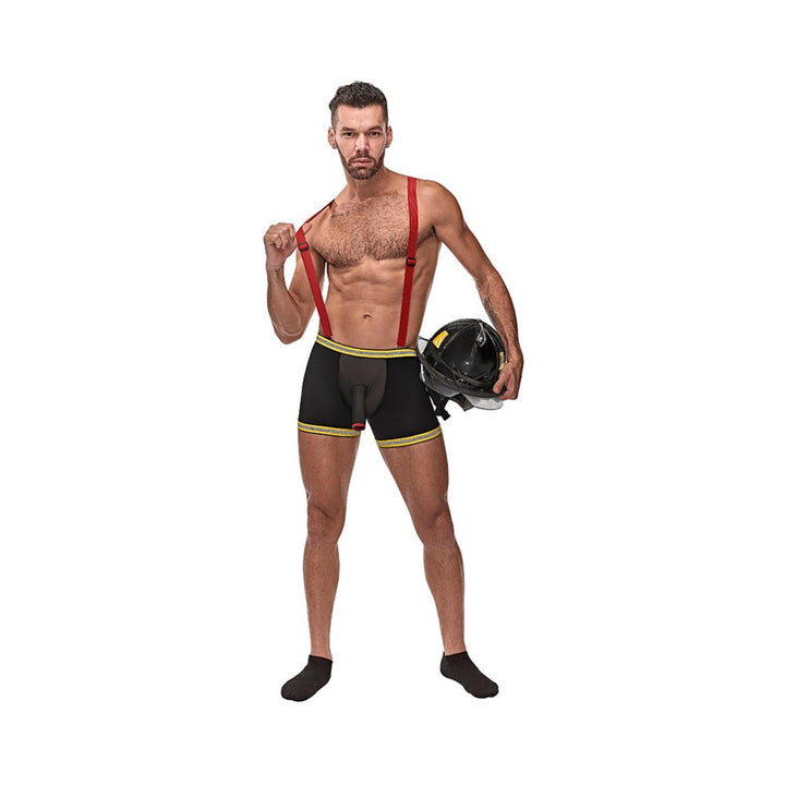 Man wearing black sheer suspender shorts with red suspenders and yellow trim holding a firefighter helmet.