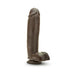 Realistic chocolate-colored dildo with suction cup base standing upright on white background.