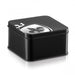 Black square metal storage case with silver fleur-de-lis emblem on the lid for discreet adult product packaging.