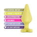 Yellow silicone anal plug with heart-shaped base shown alongside colorful icons highlighting body-safe, fragrance-free, latex-free, satin smooth, and platinum-cured features.