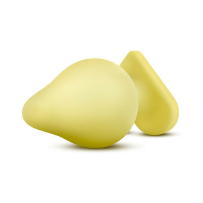 Soft yellow silicone anal plug with heart-shaped base, smooth satin finish, and playful design.
