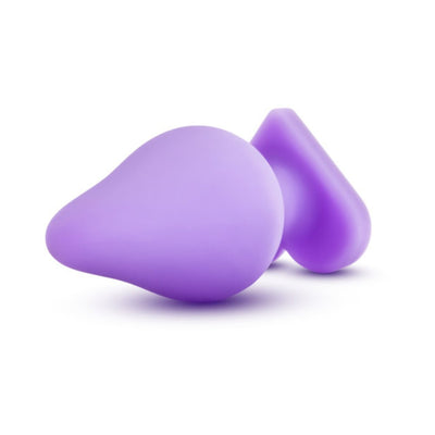 Purple silicone anal plug with heart-shaped base on white background, smooth satin finish.