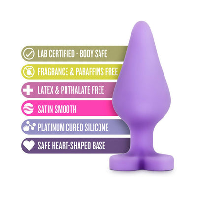 Purple silicone anal plug with heart-shaped base alongside safety and material feature icons and text.