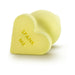 Yellow heart-shaped silicone anal plug with "SPANK ME" text on the base, smooth satin finish, flexible design.