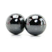 Two smooth, shiny magnetic hematite balls with reflective surfaces on a white background.