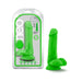 Green 6-inch dual density dildo with balls and suction cup base displayed next to its packaging.