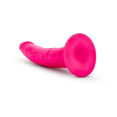 Neo Elite 7.5 inch neon pink silicone dual density dildo with suction cup base on white background.