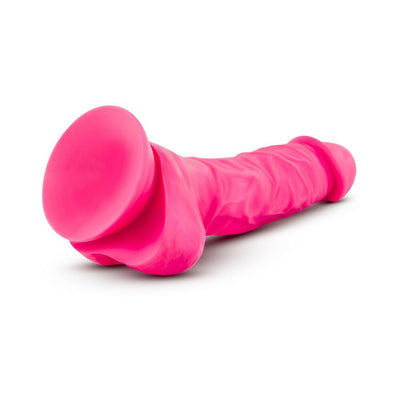 Neon pink 7.5-inch silicone dual density dildo with realistic texture and suction cup base on white background.