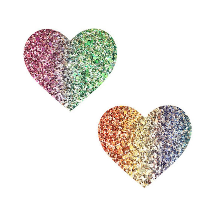 Pair of multicolor glitter heart-shaped nipple covers with a sparkling gradient design on white background.