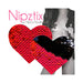 Heart-shaped red to black reversible sequin nipple covers by Neva Nude with a model in the background.