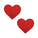 Pair of red glitter heart-shaped nipple covers on a white background for discreet, comfortable wear.