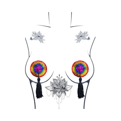 Illustration of a torso wearing reusable rainbow sequin pasties with black tassels and floral tattoos on a white background.