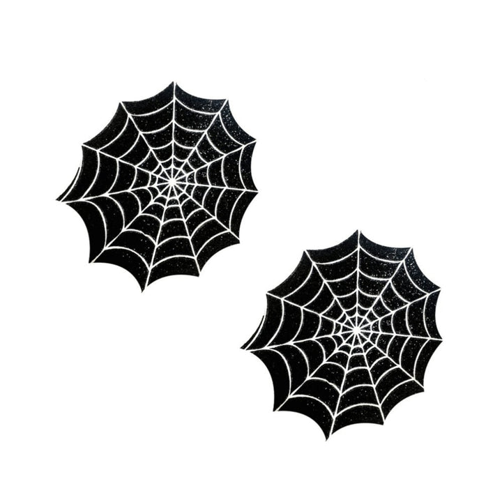 Pair of black spider web design pasties with white detailing on a white background